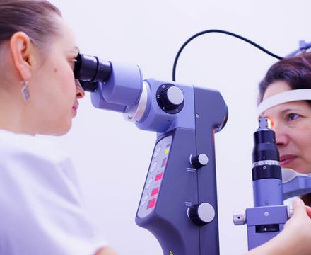 A specialist carefully checking a patient's eyes